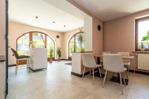 a living room with a table and chairs at Home Tatra in Biały Dunajec