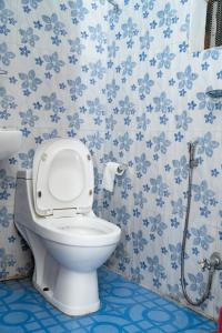 a bathroom with a toilet with blue flowers on the wall at Admire Hotel Pvt Ltd in Pokhara +35 photos
