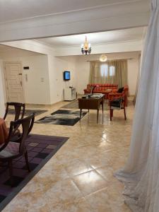 a living room with a couch and a table at Villa agamy in Burj al ‘Arab al Jadīdah
