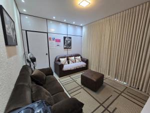 a living room with a couch and a bed at Casa Rosa in Cuiabá +60 photos