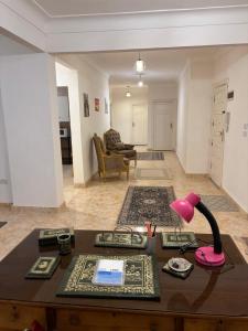 a living room with a table with a lamp on it at Villa agamy in Burj al ‘Arab al Jadīdah