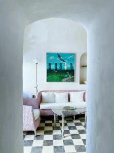 a living room with a couch and a table at Argonaut House in Anafi