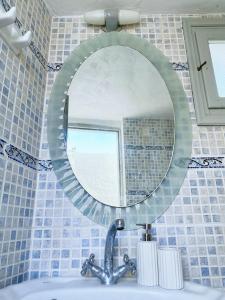 a mirror above a sink in a bathroom at Argonaut House in Anafi +36 photos