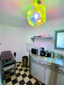 a kitchen with a counter and a chair in a room at Argonaut House in Anafi