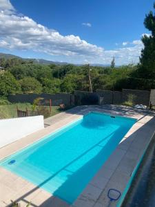 a swimming pool with blue water in a yard at Casablanca in Huerta Grande
