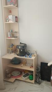 a kitchen with a shelf with a sewing machine on it at ArsonGuest in Berat +65 photos