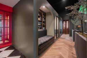 a hallway with a bench in a room with windows at The Green Escape Suite in Mexico City +33 photos