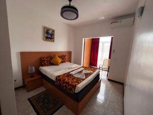 a bedroom with a bed and a large window at Isa House - Private Rooms in a Shared Duplex in Praia