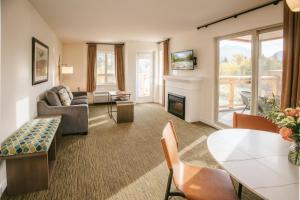 a living room with a couch and a fireplace at Executive Suites Hotel and Resort, Squamish in Squamish
