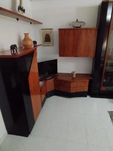 a room with a wooden desk and cabinets at Piso de Verano in O Grove +7 photos