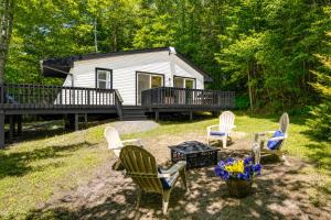 a group of chairs sitting in front of a cabin at High-Design Monroe Cabin on 2 Private Acres! in Readsboro