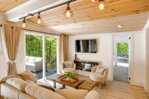 a living room with a couch and a table at High-Design Monroe Cabin on 2 Private Acres! in Readsboro