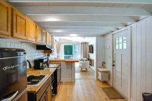 a kitchen with white cabinets and a counter top at High-Design Monroe Cabin on 2 Private Acres! in Readsboro