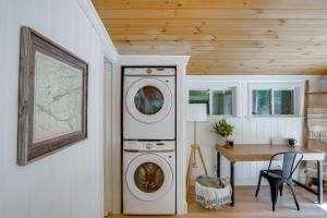 a washer and dryer in a room with a table at High-Design Monroe Cabin on 2 Private Acres! in Readsboro +19 photos