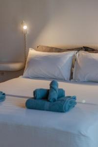 a bed with a blue stuffed animal on it at Kooreloo Airy Loft in Koroni