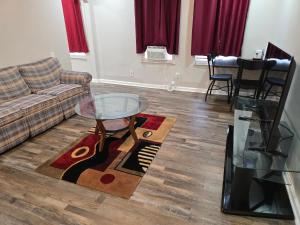 a living room with a couch and a glass table at Cozy-One in Cincinnati