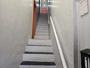 a staircase in a building with white and black steps at Cozy-One in Cincinnati
