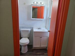 a bathroom with a white toilet and a sink at Cozy-One in Cincinnati