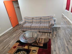 a living room with a couch and a glass table at Cozy-One in Cincinnati
