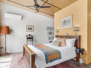 a bedroom with a bed and a ceiling fan at Lianna Bungalow in Auburn