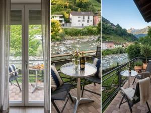 a balcony with a table and chairs and a view of a river at Arturs B&B Roveredo in Roveredo