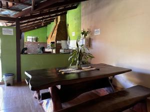 a table with a plant on it in a room at Chico de Sá Pousada in Pirenópolis