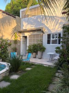 a house with two chairs and a table in front of it at Casa Loft 9C in São Luís