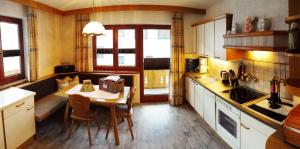 a kitchen with a table and a dining room at Haus Wachter in Pfunds