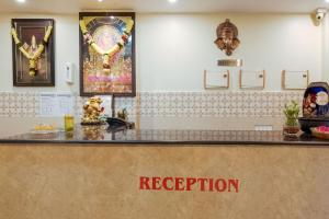a counter with a sign that reads reception at Hotel O Anu Grand in Visakhapatnam