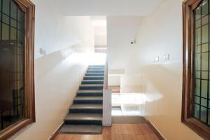 a staircase in a building with a stair case at Hotel O Anu Grand in Visakhapatnam