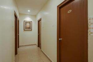 a hallway with a door leading to a room at Hotel O Anu Grand in Visakhapatnam