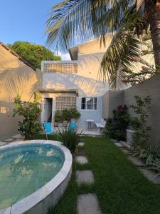a house with a swimming pool in front of a yard at Casa Loft 9C in São Luís