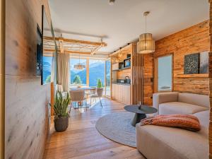 a living room with a couch and a table at Premium XL in Hollersbach im Pinzgau