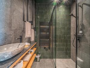 a bathroom with a sink and a glass shower at Premium XL in Hollersbach im Pinzgau +75 photos