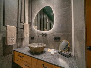 a bathroom with a bowl sink and a mirror at Premium Apartment Almrausch in Hollersbach im Pinzgau +19 photos