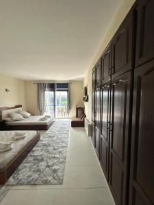 a bedroom with two beds and a large window at Chez Bouchra Suite familiale in Pont Blondin