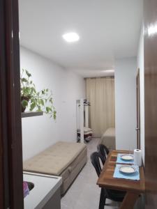 a small living room with a table and a couch at Pousada Ferreira TJ - AP 02 in Cesário Lange
