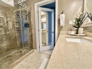 a bathroom with a glass shower and a sink at Waterfront 22' Windows Starlink Kayaks in Tobermory +70 photos