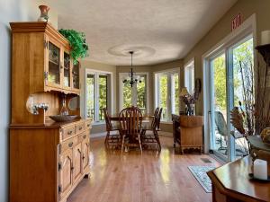 a kitchen with a table and a dining room at Waterfront 22' Windows Starlink Kayaks in Tobermory