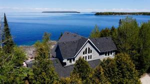 an aerial view of a house on the shore of a lake at Waterfront 22' Windows Starlink Kayaks in Tobermory