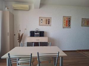 a dining room with a table and chairs and a microwave at Apartments with parking space Igrane, Makarska - 13535 in Igrane
