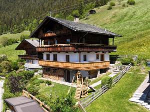 a large wooden house on top of a hill at Tirola Hütte in Alpbach