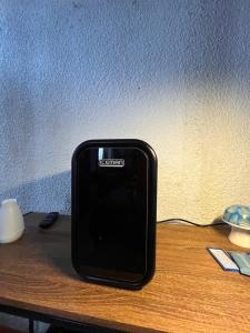 a black cell phone sitting on top of a table at Marqués 100 Exmarquesado in Oaxaca City