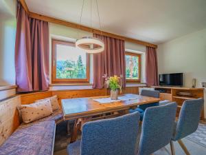 a dining room with a wooden table and chairs at Getzfeld-Hof in Westendorf