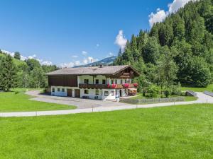 a house in the middle of a green field at Getzfeld-Hof in Westendorf