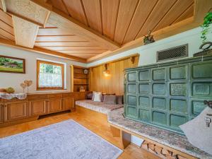 a living room with wooden walls and a wooden ceiling at Getzfeld-Hof in Westendorf