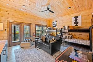 a log cabin living room with a couch and bunk beds at Top Rated Modern 3BD |Secluded |Fire Pit |Arcade in Sevierville