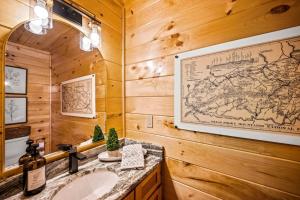 a bathroom with a sink and a map on the wall at Top Rated Modern 3BD |Secluded |Fire Pit |Arcade in Sevierville +58 photos