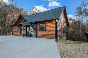 a log cabin with a driveway in front of it at Top Rated Modern 3BD |Secluded |Fire Pit |Arcade in Sevierville