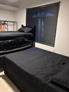 a bedroom with two bunk beds and a window at Sussurros do Mar in Bertioga +37 photos